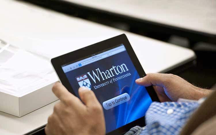 Wharton Online - participant holding a tablet