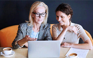 two women looking at laptop